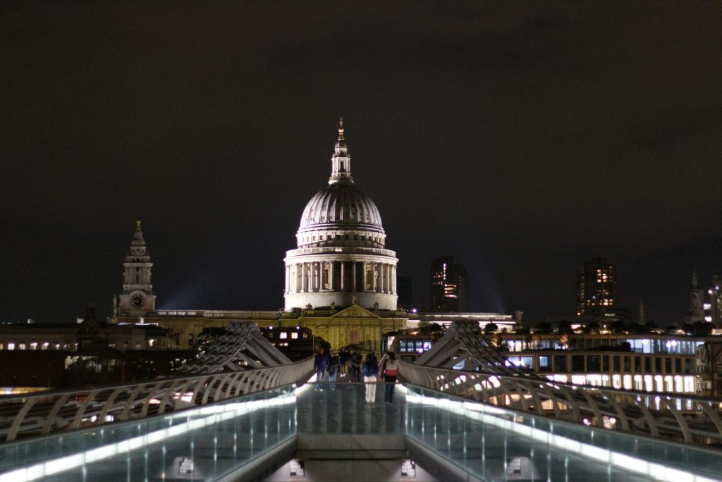 St paul's cathedral illuminated at night with millennium bridge.